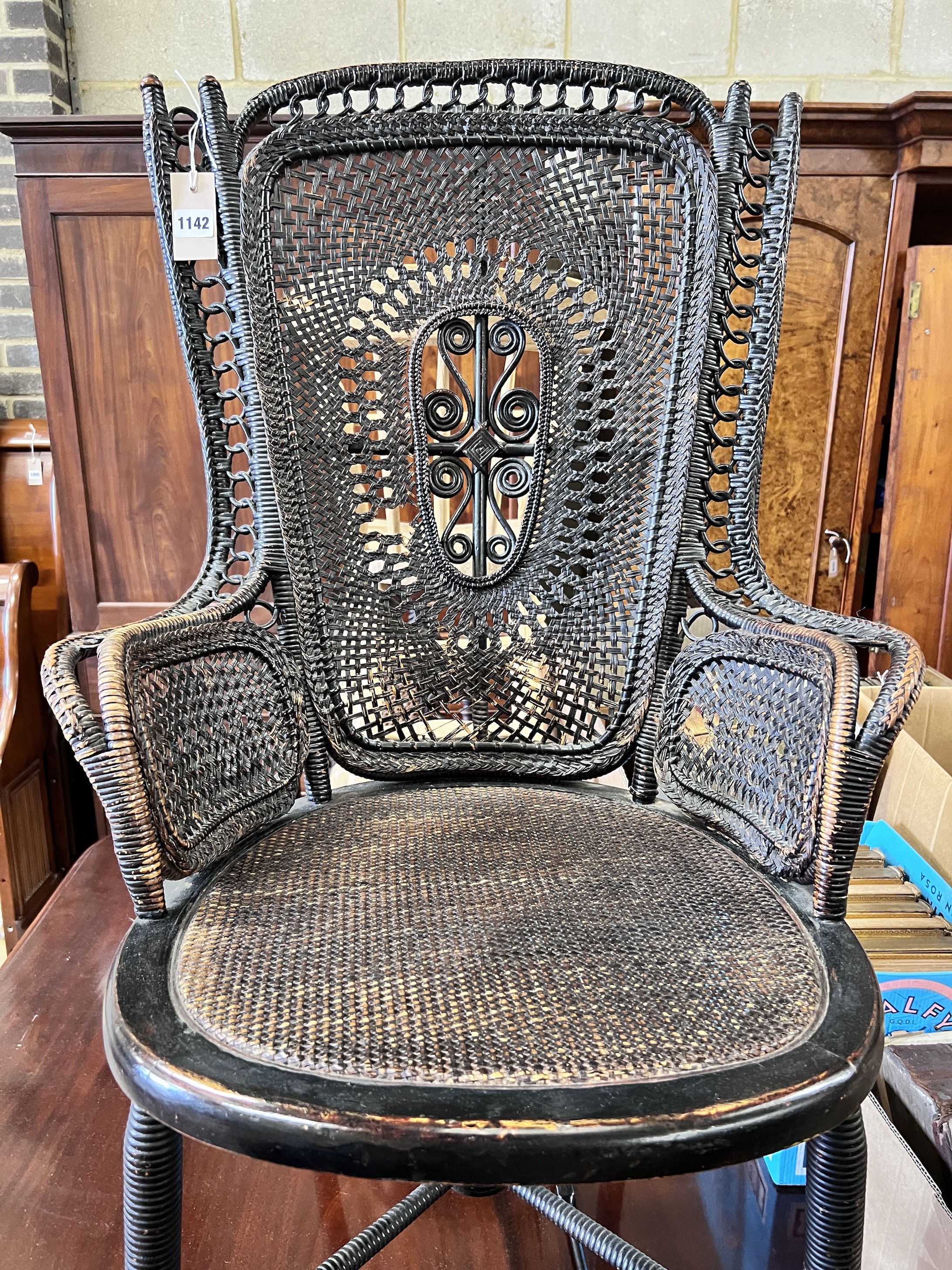 An early 20th century rattan and beech ebonised conservatory chair, height 100cm